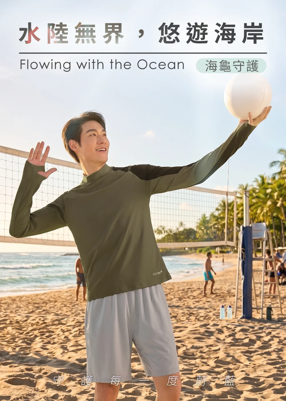 男模特兒身穿卡其灰色 UV100 海龜聯名防曬防磨衣與淺灰色運動短褲，在陽光海灘的排球網前單手托球，主打「水陸無界，悠遊海岸」的防曬機能。